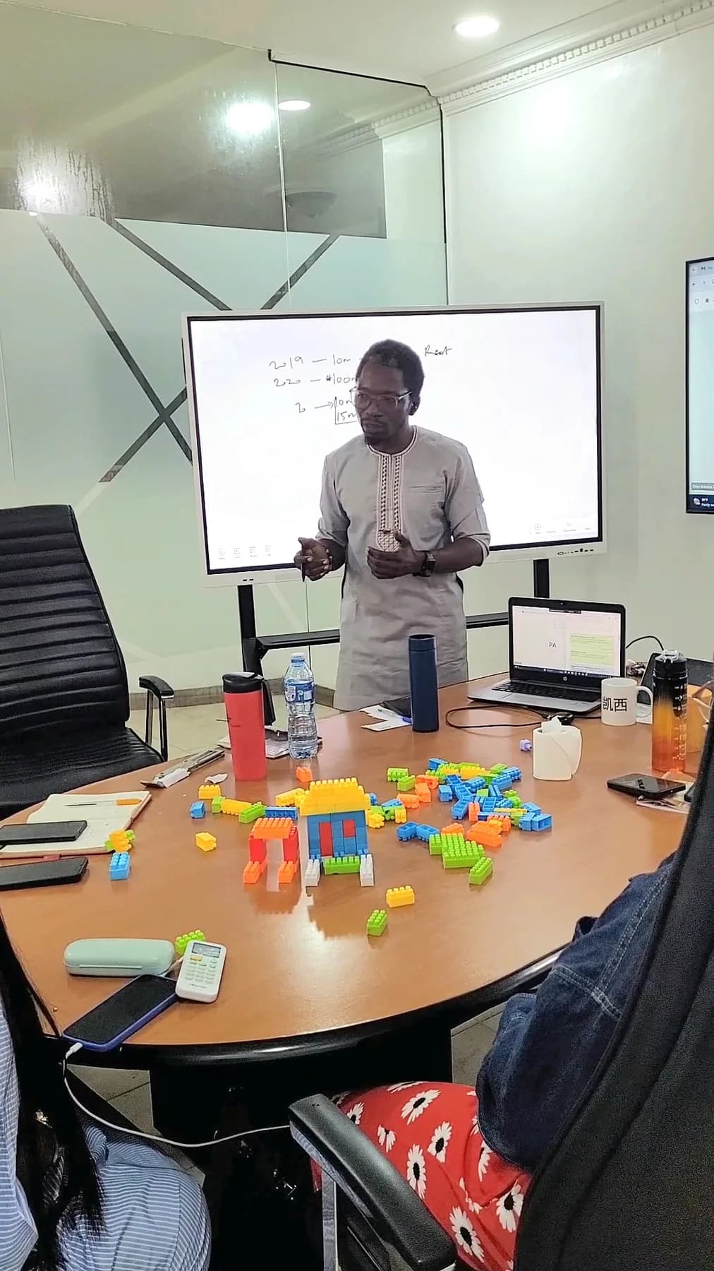 Facilitator leading an interactive agile exercise with building blocks